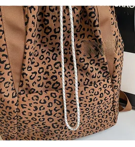 Close-up of leopard print tote bag fabric showing texture and drawstring detail