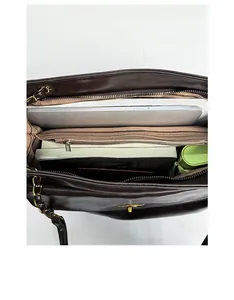 Detail of the large brown tote bag interior showing multiple functional compartments and pockets