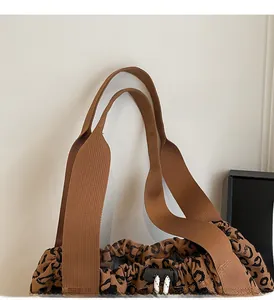 Detailed view of leopard print tote bag with reinforced handles and drawstring closure