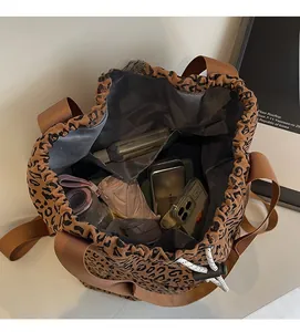 Top view of large leopard print bucket bag interior showing spacious storage for daily items