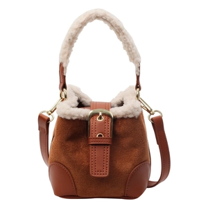 Brown suede bucket bag with faux fur trim and gold metal buckle for winter fashion