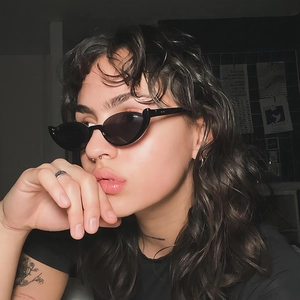 Fashionable black cat-eye semi-rimless sunglasses with avant-garde side profile look