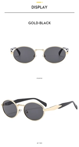 Detail view of oval retro sunglasses with gold metal frames and black lenses