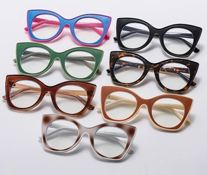 Detail view of seven colorful cat-eye eyewear frames with metal hinges and mixed patterns