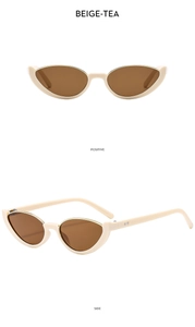 Detail view of beige cat eye sunglasses with tea lenses and silver rivet accents