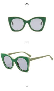 Detailed front and side view of cat-eye sunglasses with green color-blocking frame