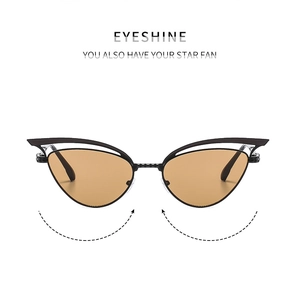 Detail der Cateye-Sonnenbrille mit hohlem Metallrahmen und braunen Brillengläsern