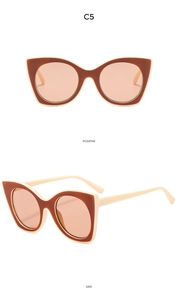 Close-up of cat-eye sunglasses with two-tone brown and beige frame and light brown lenses