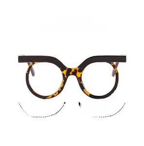 Close-up of retro round frames with dark flat top and tortoise shell lower rim detail