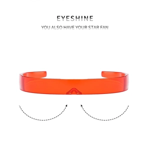 Detail of cyberpunk translucent orange wrap-around shield sunglasses with sleek lines