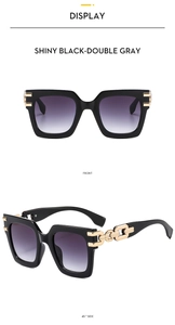 Detail view of square black sunglasses featuring elegant gold chain metal temple accents