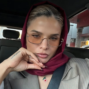 Fashionable half-rim square sunglasses with orange lenses shown in a daily lifestyle setting