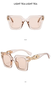 Detail of square oversized light tea sunglasses with golden chain link temple design