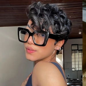 Side view of woman wearing stylish thick black square sunglasses with retro frame