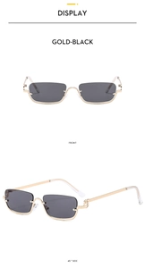 Detail view of gold metal half-frame square sunglasses with dark grey lenses and slim temples