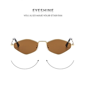 Detail of geometric gold metal sunglasses frame with brown lenses and sleek nose pads