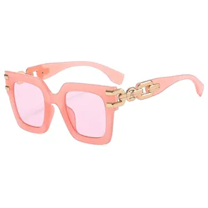 Fashionable oversized square pink sunglasses with gold chain detail on temple arms