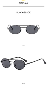 Detail view of oval double bridge sunglasses in vintage black metal frame and lenses