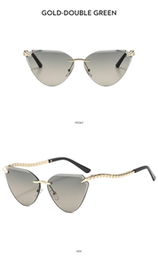 Detail einer randlosen Cat-Eye-Sonnenbrille mit goldenen Wellenbügeln und grünen Gläsern