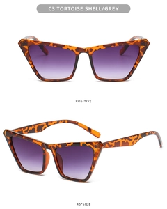 Detail of tortoise shell cat-eye sunglasses with purple gradient lenses and metal hinges