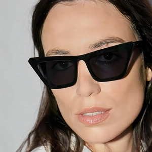 Fashionable black cat-eye sunglasses for women with wide frames on a female model