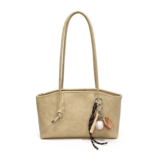 Beige PU leather underarm shoulder bag with long straps and cute baseball keychain charm.