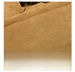 Close-up of premium brown faux suede material showing soft fuzzy texture on a backpack
