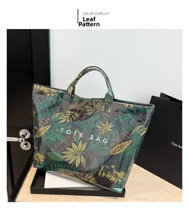 Detail of tropical leaf print tote bag with waterproof glossy finish and bold text