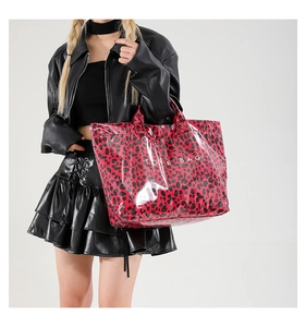 Detailed view of red and black leopard print tote bag in glossy PVC finish