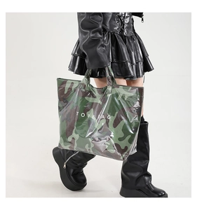 Detail of waterproof camouflage tote bag with clear PVC layer and white TOTE BAG text