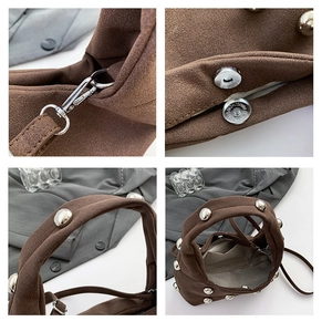 Detailed macro view of silver rivets and magnetic clasp on dark brown suede crossbody bag