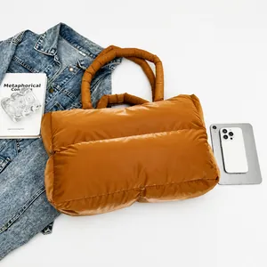 Detailed top view of the caramel quilted puffer tote bag with laptop and accessories