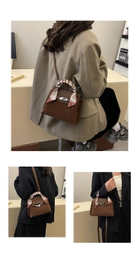 Brown matte suede handbag with patterned silk scarf handle and elegant metal clasp