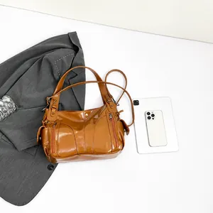 Brown glossy PU leather tote showing side zipper detail and spacious interior capacity