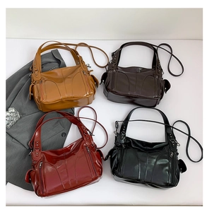Flat lay of glossy multi-pocket tote bags in camel, dark brown, burgundy, and black colors