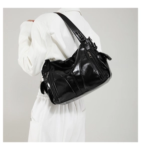 Classic black patent leather shoulder bag with multi-pocket design for women commute.