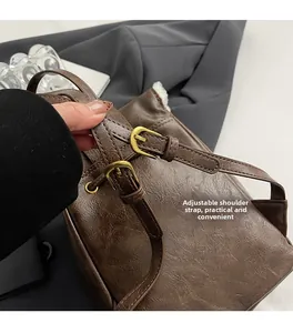 Macro shot of brown retro PU leather backpack with adjustable straps and metal buckles