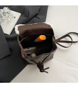 Interior view of brown faux leather backpack with drawstring closure and inner pocket