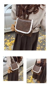 Close-up of retro brown leather backpack with white plush trim and cute bear charm detail
