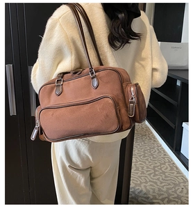 Brown frosted suede shoulder bag with multi-pocket details shown on model