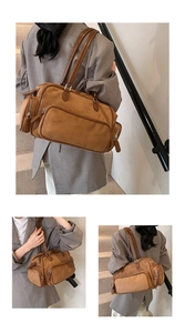 Detailed close-up of brown suede shoulder bag with multiple functional zip pockets