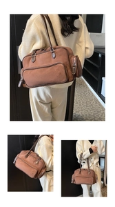 Detail view of large brown faux suede shoulder bag with multi-zipper pocket structure