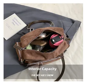 Detail view of brown suede handbag interior showing large capacity and multiple pockets
