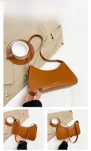Detailed views of a brown leather shoulder bag with a curved silhouette and zipper closure