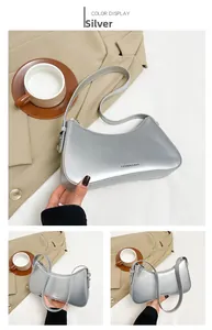 Detailed view of silver metallic underarm bag with Fashion & Bag text logo