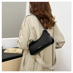 Close-up of minimalist black hobo bag with Fashion & Bag text styled with a trench coat