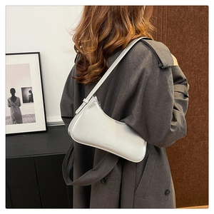 Silver metallic shoulder bag worn as an underarm purse with sleek finish