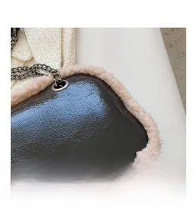 Detailed view of the wrinkled patent leather texture and plush faux fur trim on the chain bag