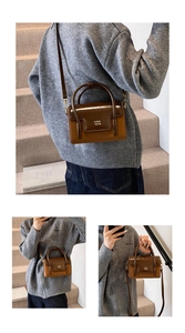 Detail view of brown patchwork square bag with glossy patent leather and gold logo