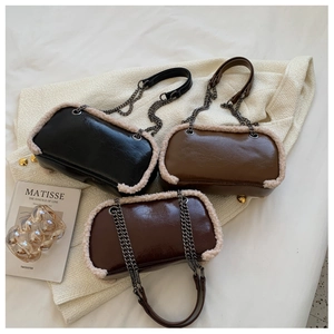 Detailed view of vintage chain bags with faux lamb fur trim in three autumn colors